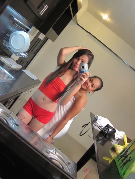 Filipina teen takes self shots while getting bare naked on a kitchen counter