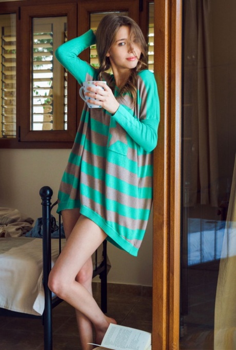 Young Ukrainian solo girl Mila Azul gets naked in front of her open window