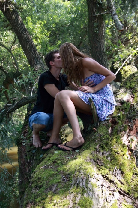 Tall teen Kitty Jane has sex with her boyfriend on a tree limb over the water