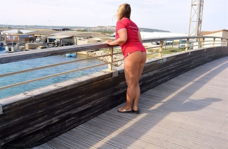 Mature fatty Chrissy walks by the sea with her round big tits bared