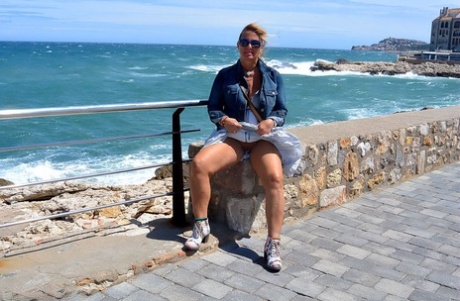 Mature fatty Chrissy walks by the sea with her round big tits bared