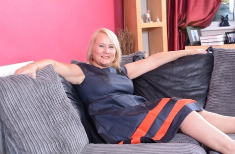 Older blonde fatty toys her vagina on a sofa while making her nude debut