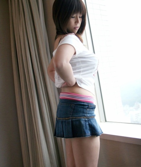 Japanese teen Haduki uncovers her great tits and hairy bush as she disrobes