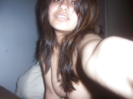 Indian girl removes her headset before taking selfies of her big tits