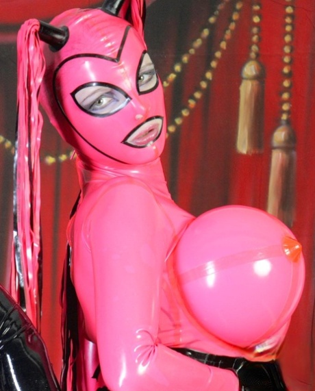 Lesbian lovers sport latex outfits with massively oversized breasts