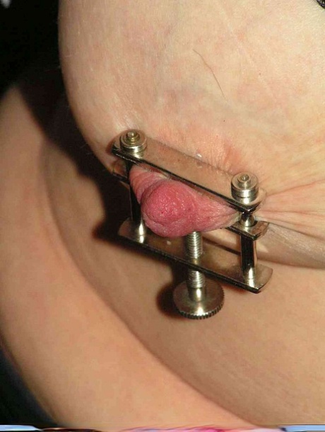 Restrained blonde lady has her nipples clamped and pierced with needles