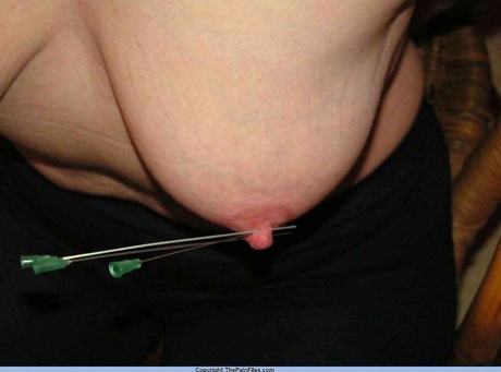 Restrained blonde lady has her nipples clamped and pierced with needles