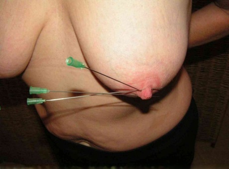 Restrained blonde lady has her nipples clamped and pierced with needles