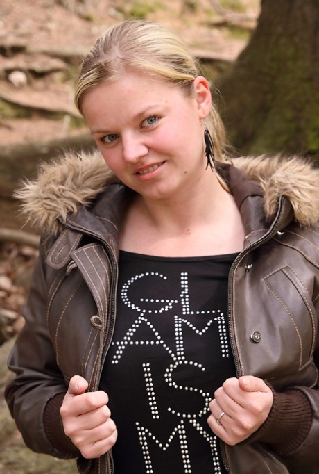 Chubby blonde sets her big natural boobs and butt free while in the woods