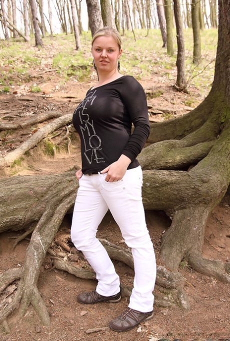 Chubby blonde sets her big natural boobs and butt free while in the woods