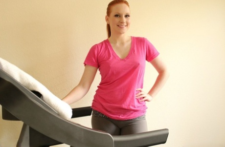 Fit redhead Lucy OHara pauses her workout to shove a dildo in her tight pussy