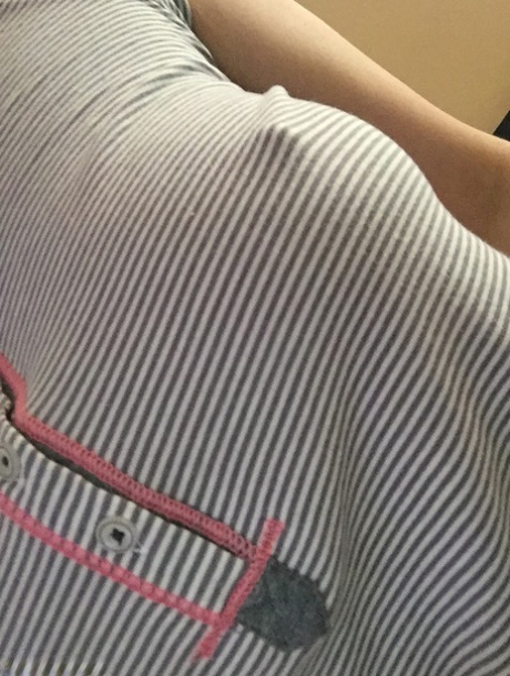 Nerdy female Amber Hahn exposes her hooters for self shots on bed