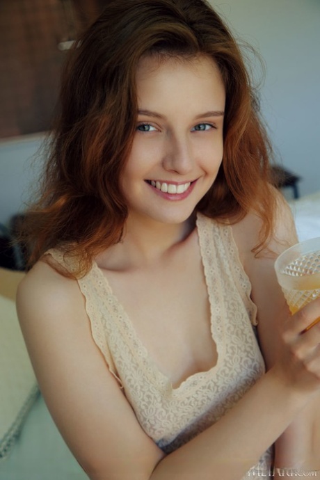 Young redhead Sienna wakes up before showing her bald pussy on her bed