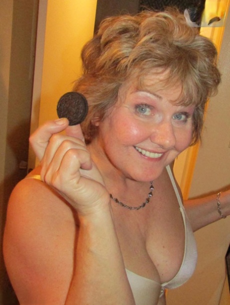 Mature woman Busty Bliss uncovers her natural boobs before pleasuring a penis
