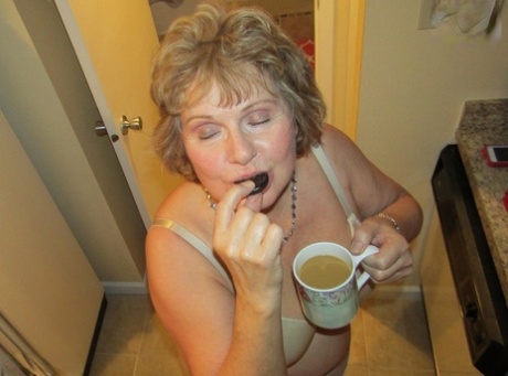 Mature woman Busty Bliss uncovers her natural boobs before pleasuring a penis