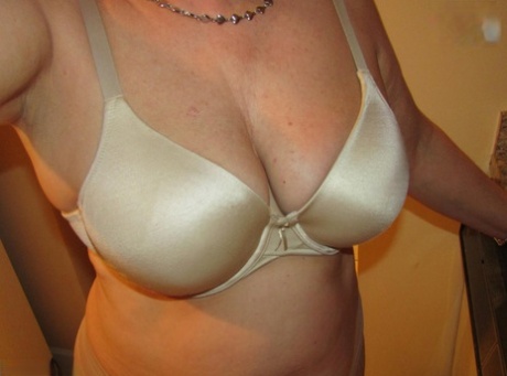 Mature woman Busty Bliss uncovers her natural boobs before pleasuring a penis