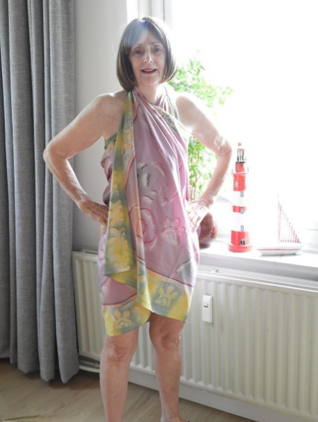 Old lady Kat Kitty removes a bikini on her way to getting totally naked