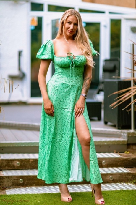 Hot UK blonde Danielle Maye unleashes her big tits on a patio in high heels