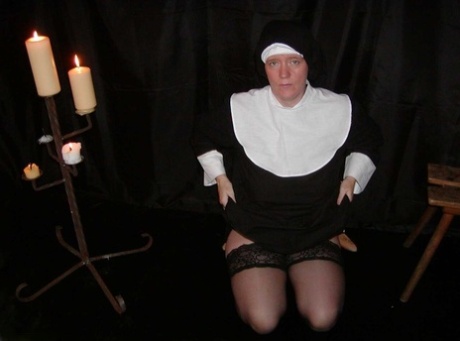 Mature nun Tiffany Pearl gets naked in a veil and a pair of stockings
