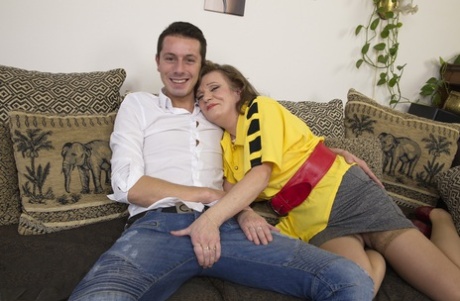 Horny cougar gets banged doggystyle after being undressed by her toy boy