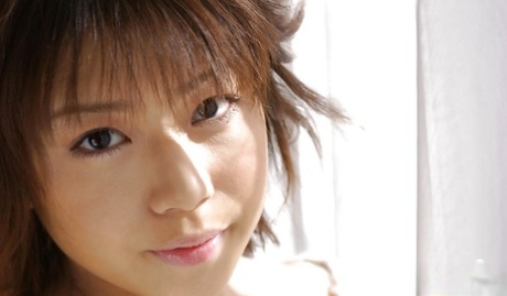 Big busted asian babe Mai Haruna stripping and licking her hard nipples