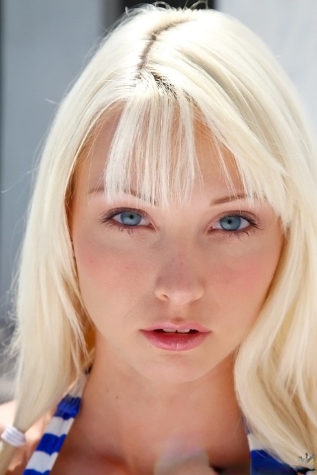 Doll-face teenage blonde with big tits Rikki Six slipping off her bikini