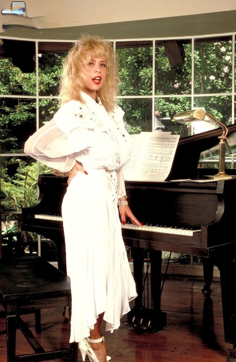 Hot pianist MILF Tiffany Towers disrobes to flaunt her extremely big tits