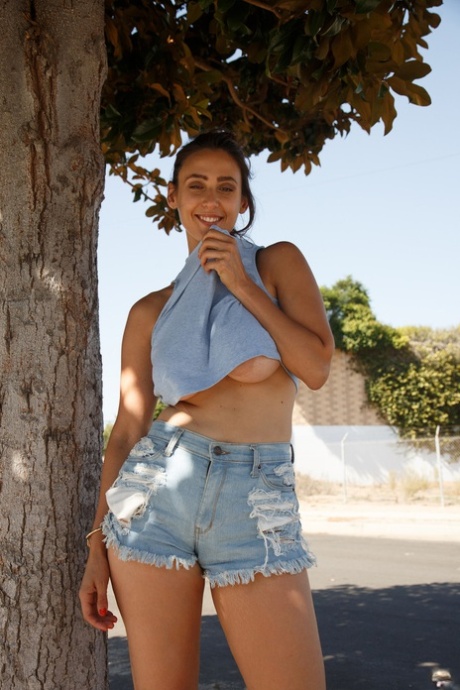 Stunner with big tits Rhonda Biasi posing braless in sexy shirt & shorts