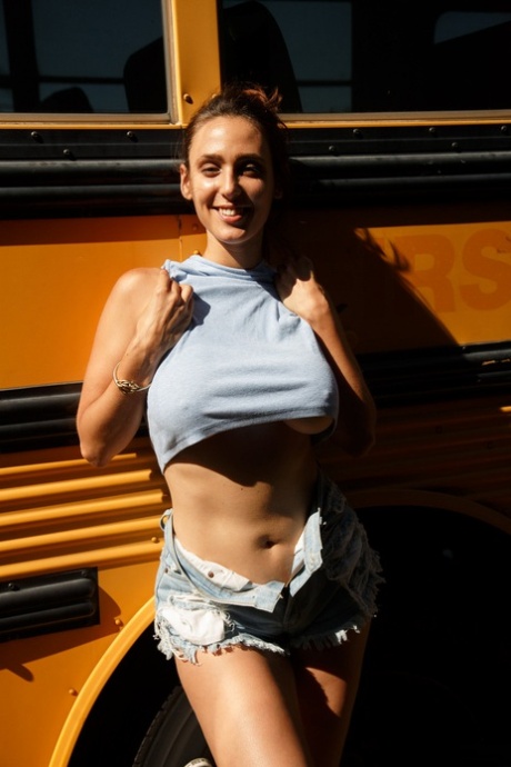 Stunner with big tits Rhonda Biasi posing braless in sexy shirt & shorts