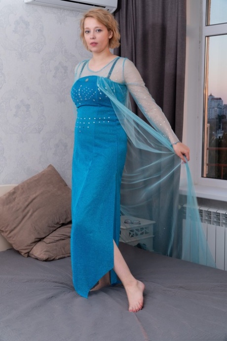 Elegant babe Uli removes her dress and lingerie to finger her hairy pussy