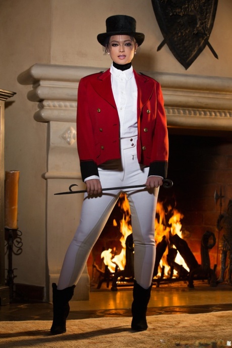 Glamorous centerfold Chelsie Aryn flaunts big fake tits erotically by the fire
