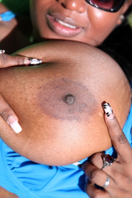 Sweet amateur ebony Jenny reveals her massive juggs and poses outdoors