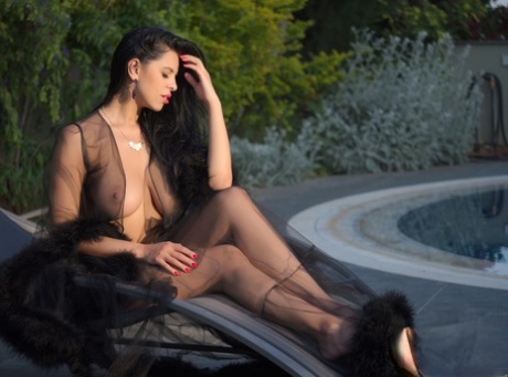 Big breasted Russian bimbo Kira Queen posing in her sheer lingerie outdoors