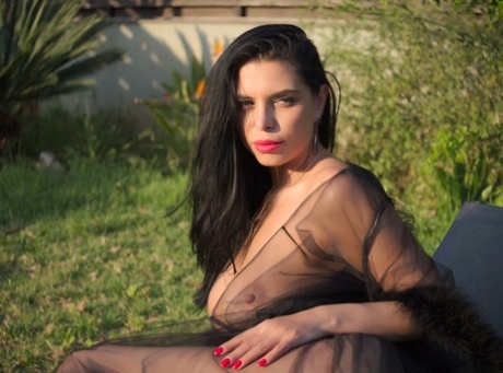 Big breasted Russian bimbo Kira Queen posing in her sheer lingerie outdoors