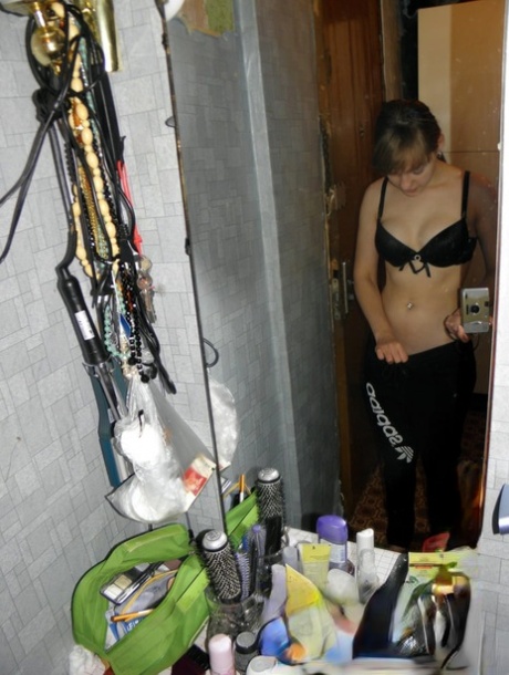 Amateur girl with a nice bum stripping and posing in the mirror