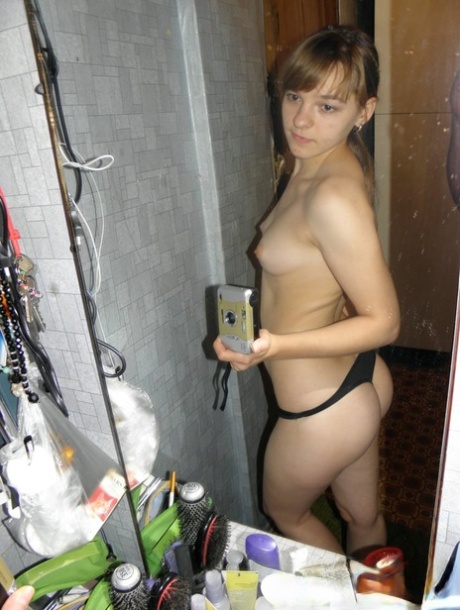 Amateur girl with a nice bum stripping and posing in the mirror