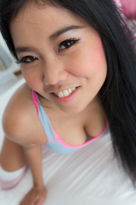 Lovely Asian girl Sanouk shows off her perfect tits & her tight shaved pussy