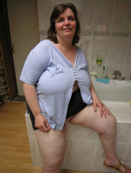 Old fatty with big boobs Eefje rides a sex toy after stripping on a bed