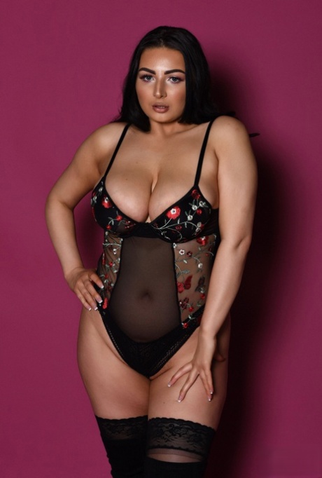 Chubby babe Foxy Lucina exposes her fabulous juggs while posing in stockings