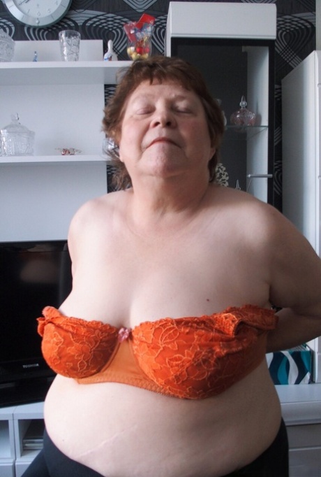 Naughty chubby granny Hortensia plays with her big tits while undressing