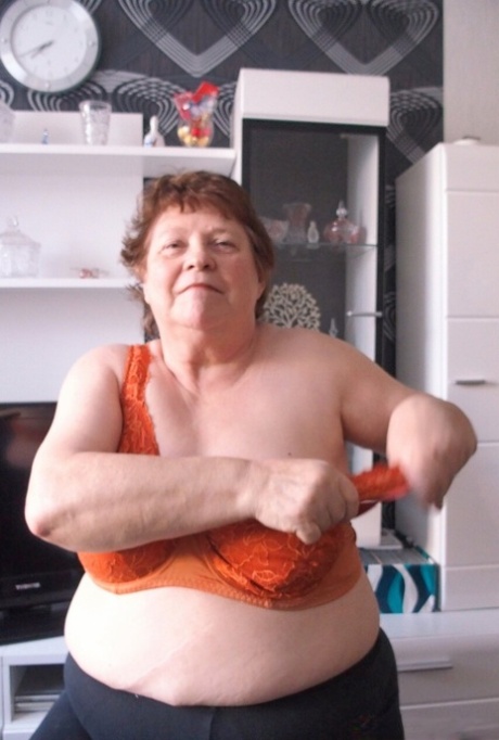 Naughty chubby granny Hortensia plays with her big tits while undressing