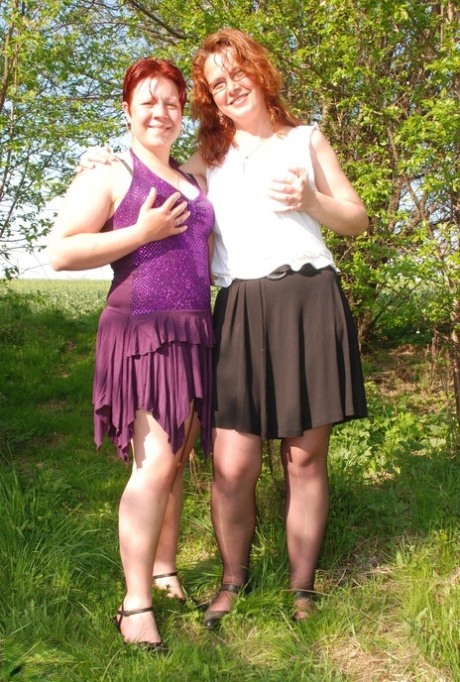 Fat redheaded lesbians Jenna K & Monica D rub each other's clits in nature